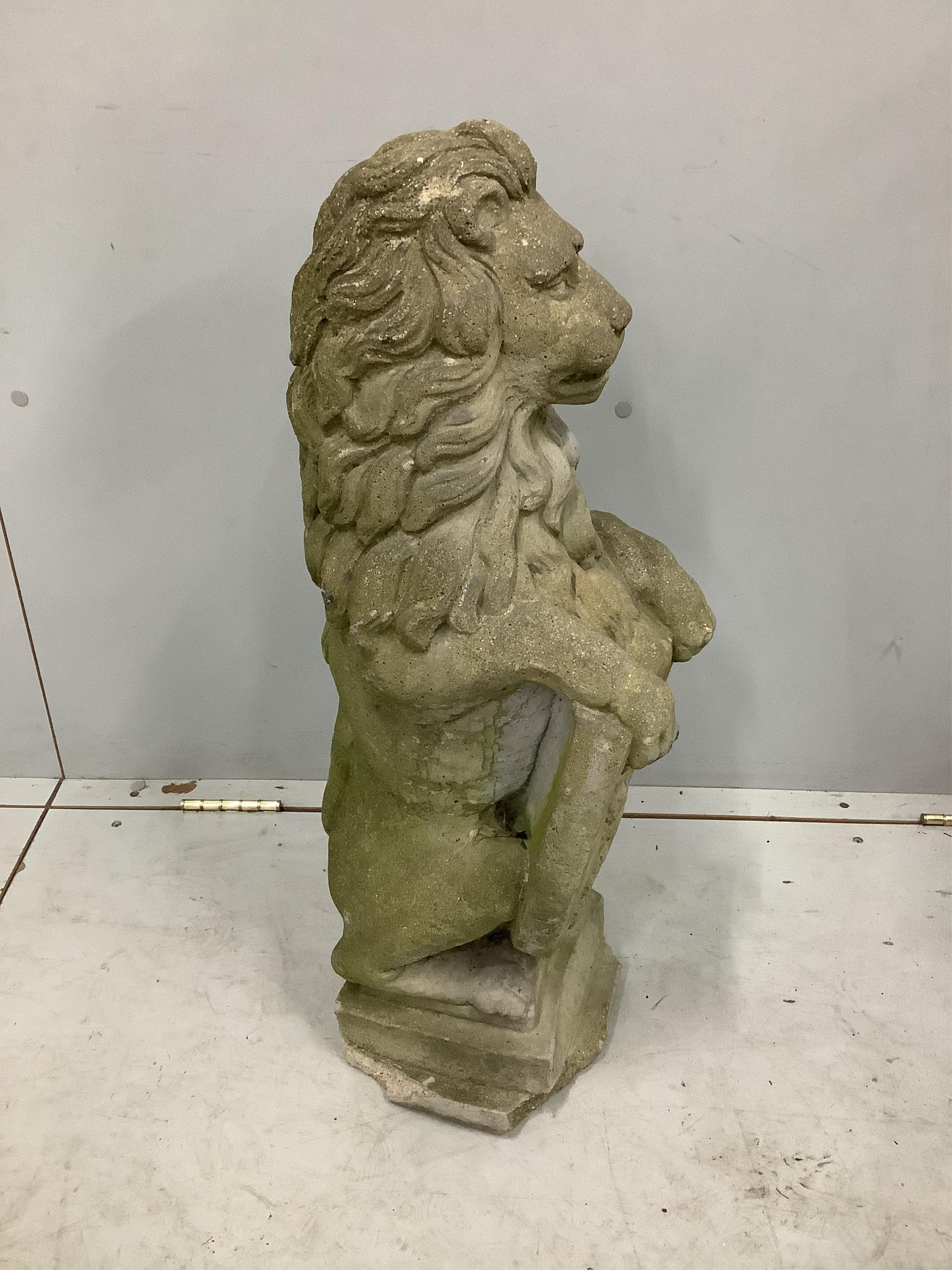 A reconstituted stone heraldic lion garden ornament, height 72cm. Condition - poor to fair, plinth base chipped